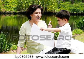 Stock Photo - an old lady praising 
his grandson's 
drawing. fotosearch 
- search stock 
photos, pictures, 
images, and photo 
clipart