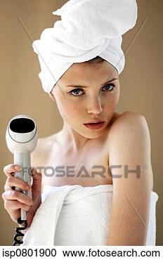 Stock Photography - a woman with her 
hair and body 
wrapped up in 
towel holding 
a hairdryer. fotosearch 
- search stock 
photos, pictures, 
images, and photo 
clipart