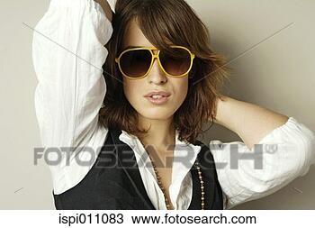 Stock Photo - woman in sunglasses 
posing for the 
camera. fotosearch 
- search stock 
photos, pictures, 
images, and photo 
clipart