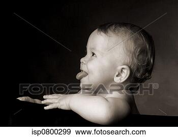 Stock Photograph - side shot of a 
boy showing his 
tongue. fotosearch 
- search stock 
photos, pictures, 
images, and photo 
clipart