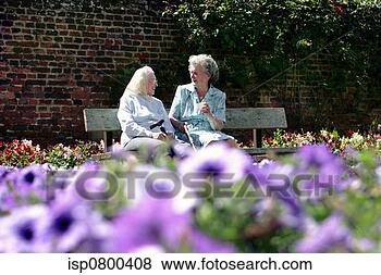 Stock Photo - two old women 
sitting on a bench 
in the garden 
talking. fotosearch 
- search stock 
photos, pictures, 
images, and photo 
clipart