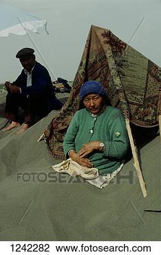 Stock Photo - a man and a woman 
resting in the 
sand dunes at 
a health spa, 
 turfan. fotosearch 
- search stock 
photos, pictures, 
images, and photo 
clipart
