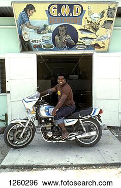 Stock Photo - a man on a motorcycle 
outside of a restaurant, 
nauru. fotosearch 
- search stock 
photos, pictures, 
images, and photo 
clipart