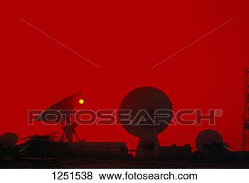 Pictures of The silhouette of satellite dishes against a red sky...