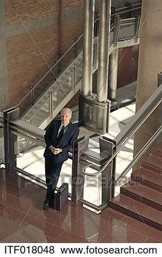 Stock Photo - businessman standing 
by a flight of 
stairs. fotosearch 
- search stock 
photos, pictures, 
images, and photo 
clipart