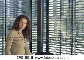 Stock Photograph - portrait of a 
businesswoman 
standing in front 
of a window. fotosearch 
- search stock 
photos, pictures, 
images, and photo 
clipart