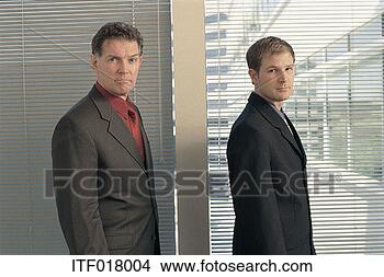Stock Photo - portrait of two 
businessmen standing 
at a window. fotosearch 
- search stock 
photos, pictures, 
images, and photo 
clipart