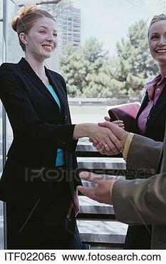 Stock Image - businesswoman 
having her hand 
shaken. fotosearch 
- search stock 
photos, pictures, 
images, and photo 
clipart