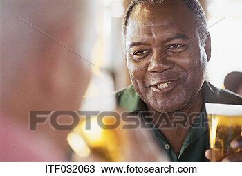 Stock Photo - close-up of a 
mature man smiling 
and holding a 
glass of beer. 
fotosearch - search 
stock photos, 
pictures, images, 
and photo clipart