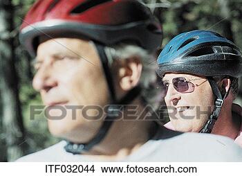 Stock Photo - close-up of two 
men wearing cycle 
helmets. fotosearch 
- search stock 
photos, pictures, 
images, and photo 
clipart