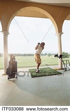 Stock Photo - mature man practising 
golf on a driving 
range. fotosearch 
- search stock 
photos, pictures, 
images, and photo 
clipart