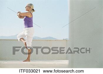 Stock Photography - mature woman practising 
yoga on a balcony. 
fotosearch - search 
stock photos, 
pictures, images, 
and photo clipart