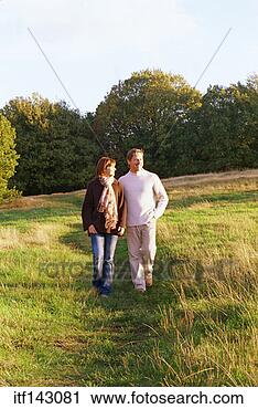 Stock Photography - couple taking 
romantic walk 
in woods. fotosearch 
- search stock 
photos, pictures, 
images, and photo 
clipart
