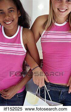 Stock Image - two girls arm-in-arm, 
dressed alike. 
fotosearch - search 
stock photos, 
pictures, images, 
and photo clipart