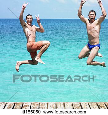 Stock Photography - men making hand 
gestures while 
jumping off dock 
and into water. 
fotosearch - search 
stock photos, 
pictures, images, 
and photo clipart