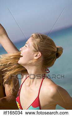 Stock Photo - woman at beach 
raising arm. fotosearch 
- search stock 
photos, pictures, 
images, and photo 
clipart