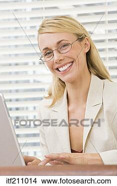 Stock Photo - smiling businesswoman 
at laptop. fotosearch 
- search stock 
photos, pictures, 
images, and photo 
clipart