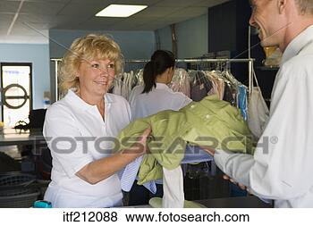 Stock Photo - clerk at dry cleaners. 
fotosearch - search 
stock photos, 
pictures, images, 
and photo clipart