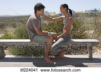 Stock Photography - couple sitting 
at bench on beach. 
fotosearch - search 
stock photos, 
pictures, images, 
and photo clipart