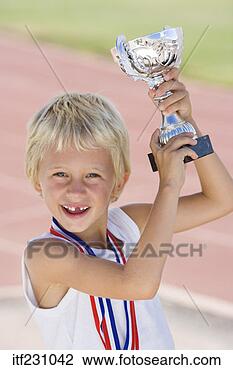 Stock Photo - boy holding trophy. 
fotosearch - search 
stock photos, 
pictures, images, 
and photo clipart