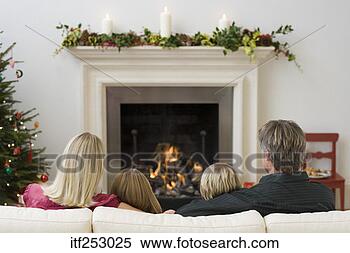 Stock Image - family sitting 
in front of fireplace. 
fotosearch - search 
stock photos, 
pictures, images, 
and photo clipart