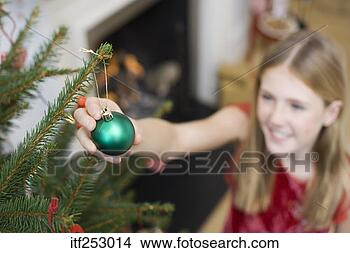 Stock Photo - girl decorating 
christmas tree. 
fotosearch - search 
stock photos, 
pictures, images, 
and photo clipart