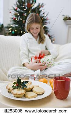 Stock Photo - girl with milk, 
cookies, and christmas 
present. fotosearch 
- search stock 
photos, pictures, 
images, and photo 
clipart