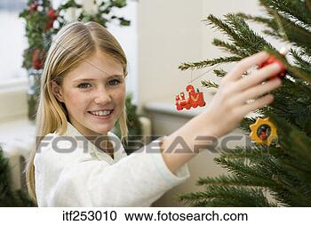 Stock Photography - smiling girl decorating 
christmas tree. 
fotosearch - search 
stock photos, 
pictures, images, 
and photo clipart