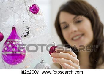 Picture - woman putting 
ornament on christmas 
tree. fotosearch 
- search stock 
photos, pictures, 
images, and photo 
clipart