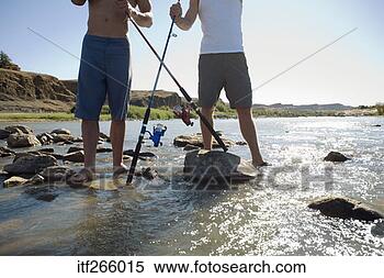 Stock Image - men standing in 
stream with fishing 
poles. fotosearch 
- search stock 
photos, pictures, 
images, and photo 
clipart