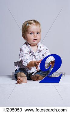 Stock Photography - baby girl holding 
number. fotosearch 
- search stock 
photos, pictures, 
images, and photo 
clipart
