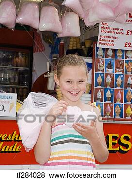 Stock Photo - girl eating cotton 
candy by food 
stand. fotosearch 
- search stock 
photos, pictures, 
images, and photo 
clipart