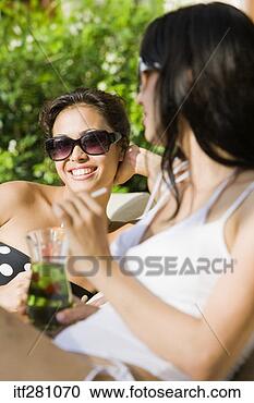 Stock Photography - friends lounging 
in swimsuits. 
fotosearch - search 
stock photos, 
pictures, images, 
and photo clipart