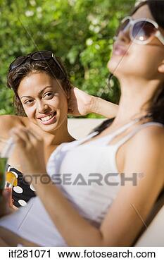 Stock Photography - friends lounging 
in swimsuits. 
fotosearch - search 
stock photos, 
pictures, images, 
and photo clipart