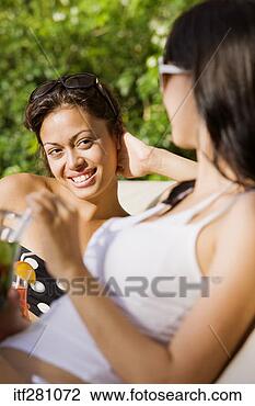 Stock Photo - friends lounging 
in swimsuits. 
fotosearch - search 
stock photos, 
pictures, images, 
and photo clipart