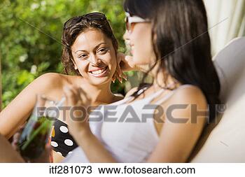 Stock Photo - friends lounging 
in swimsuits. 
fotosearch - search 
stock photos, 
pictures, images, 
and photo clipart