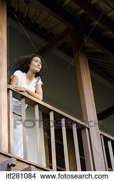 Stock Photo - pensive woman 
standing on balcony. 
fotosearch - search 
stock photos, 
pictures, images, 
and photo clipart