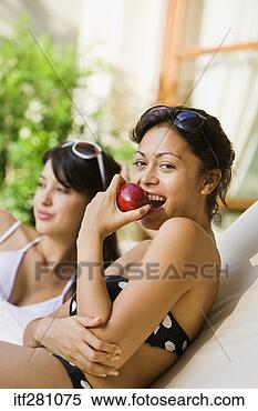 Stock Image - woman in bikini 
eating apple. 
fotosearch - search 
stock photos, 
pictures, images, 
and photo clipart