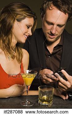 Stock Photo - man programming 
phone number of 
woman. fotosearch 
- search stock 
photos, pictures, 
images, and photo 
clipart