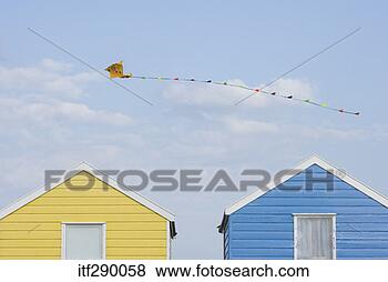 Stock Photo - kite flying over 
beach huts. fotosearch 
- search stock 
photos, pictures, 
images, and photo 
clipart
