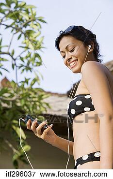 Picture - woman in bikini 
listening to music. 
fotosearch - search 
stock photos, 
pictures, images, 
and photo clipart