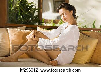 Stock Photo - woman sitting 
on couch. fotosearch 
- search stock 
photos, pictures, 
images, and photo 
clipart