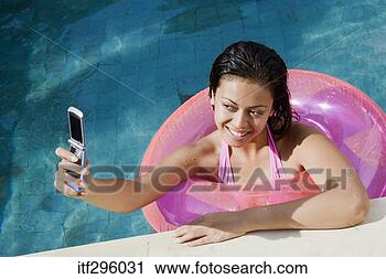 Stock Photography - woman taking picture 
in pool with camera 
phone. fotosearch 
- search stock 
photos, pictures, 
images, and photo 
clipart