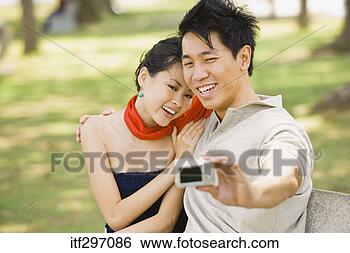 Stock Photo - couple with a 
camera. fotosearch 
- search stock 
photos, pictures, 
images, and photo 
clipart