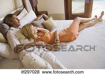 Stock Photo - couple lounging 
on a bed. fotosearch 
- search stock 
photos, pictures, 
images, and photo 
clipart