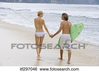 Stock Photo - couple with a 
surfboard. fotosearch 
- search stock 
photos, pictures, 
images, and photo 
clipart