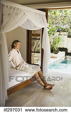 Stock Photography - man lounging on 
a bed. fotosearch 
- search stock 
photos, pictures, 
images, and photo 
clipart