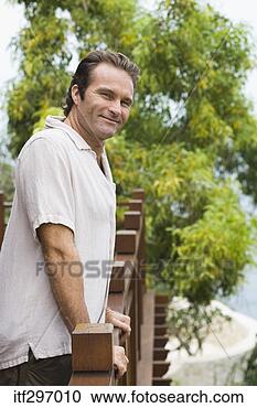 Stock Photography - smiling man by 
a railing. fotosearch 
- search stock 
photos, pictures, 
images, and photo 
clipart