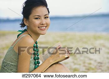 Stock Photo - woman with a book 
on a beach. fotosearch 
- search stock 
photos, pictures, 
images, and photo 
clipart