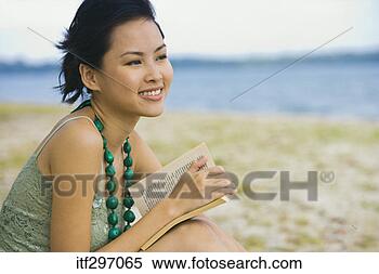 Stock Image - woman with a book 
on a beach. fotosearch 
- search stock 
photos, pictures, 
images, and photo 
clipart